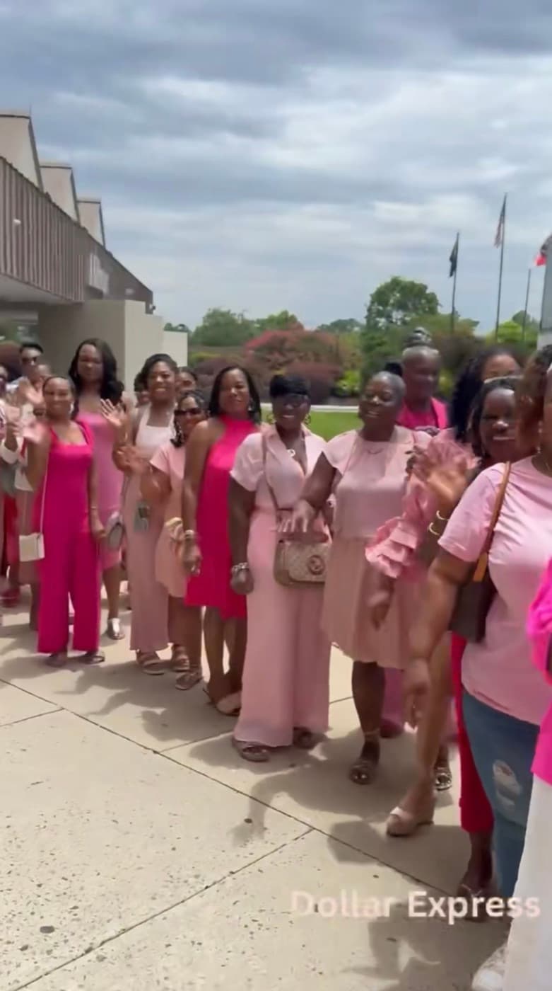 Ladies dressed in shades of pink lined up outside during the Charlotte Bus Tour