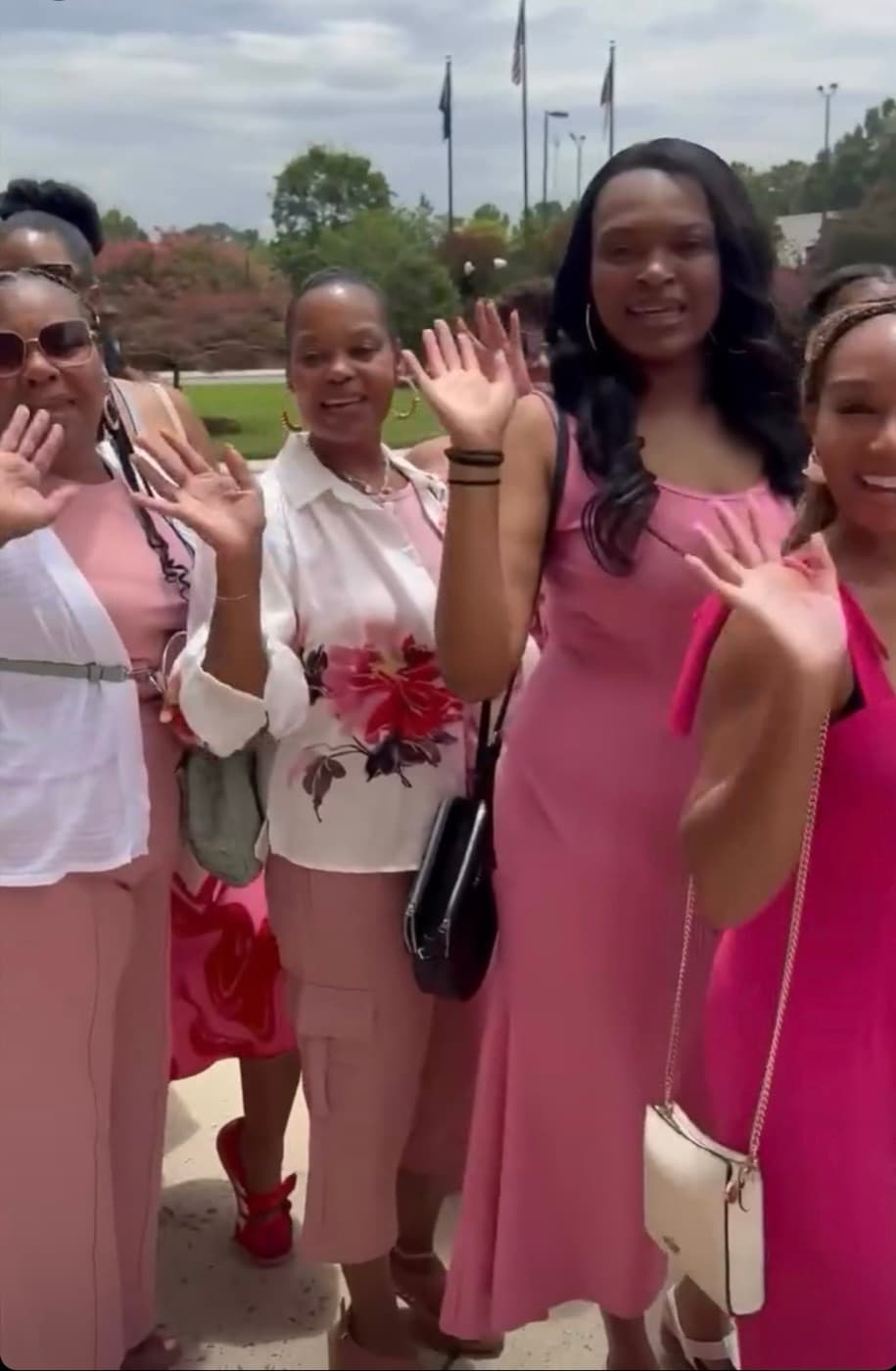 LIPSC members in pink waving during the 50 Shades of Pink Charlotte Bus Tour