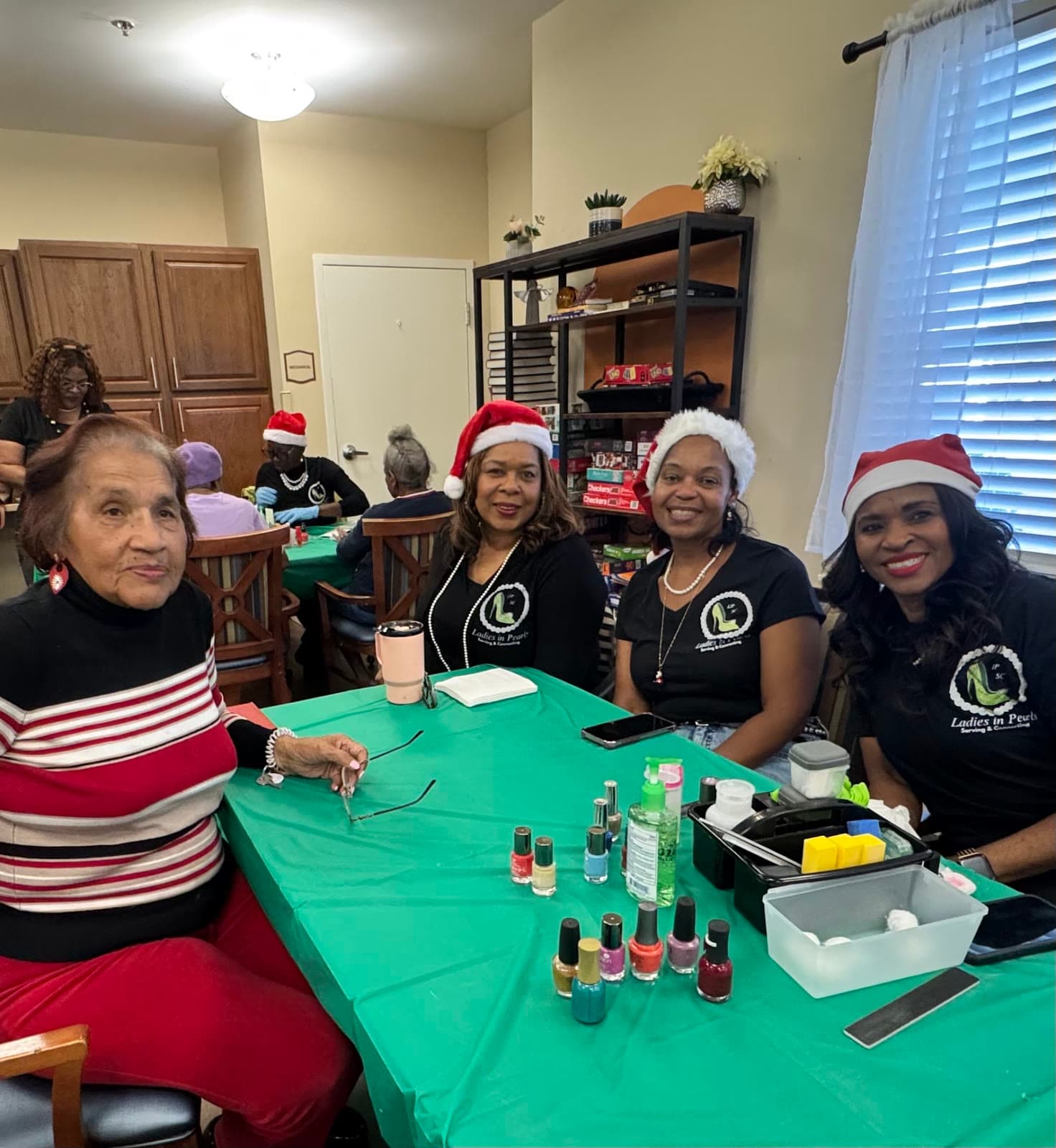 LIPSC volunteers and seniors together at a holiday Nail Ministry visit