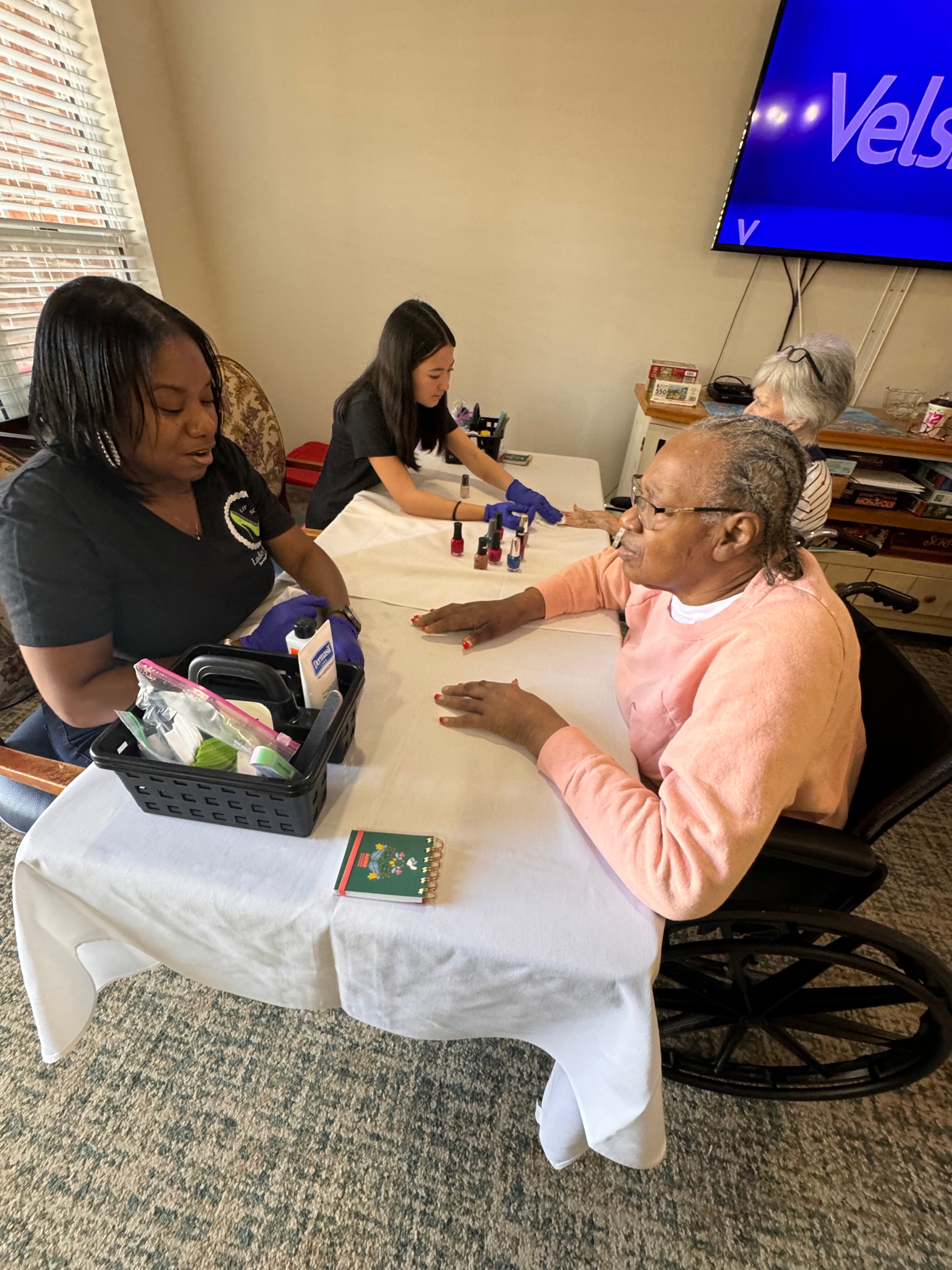 LIPSC volunteer polishing the nails of a senior resident