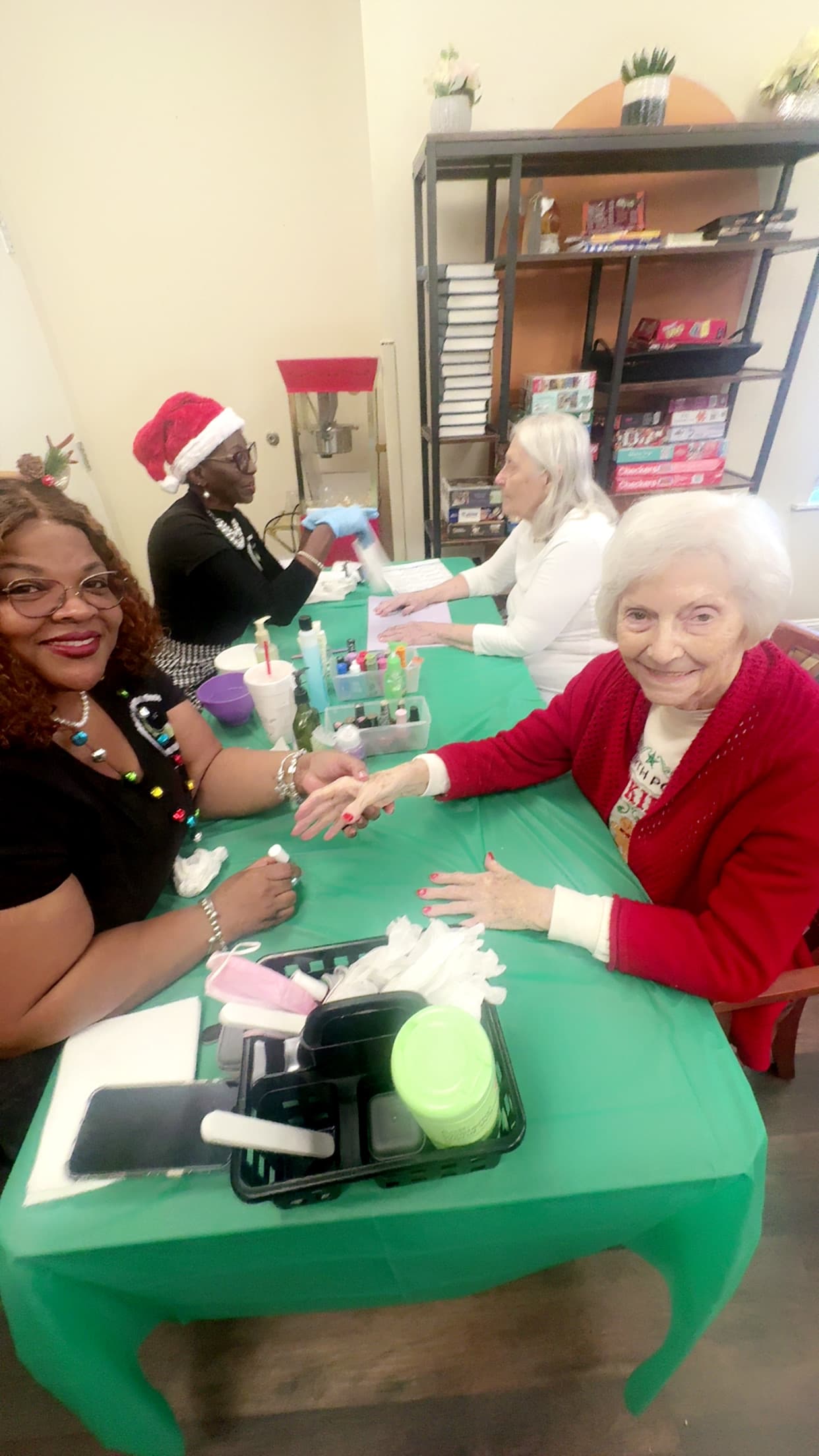 LIPSC volunteers polishing nails for seniors during a holiday visit