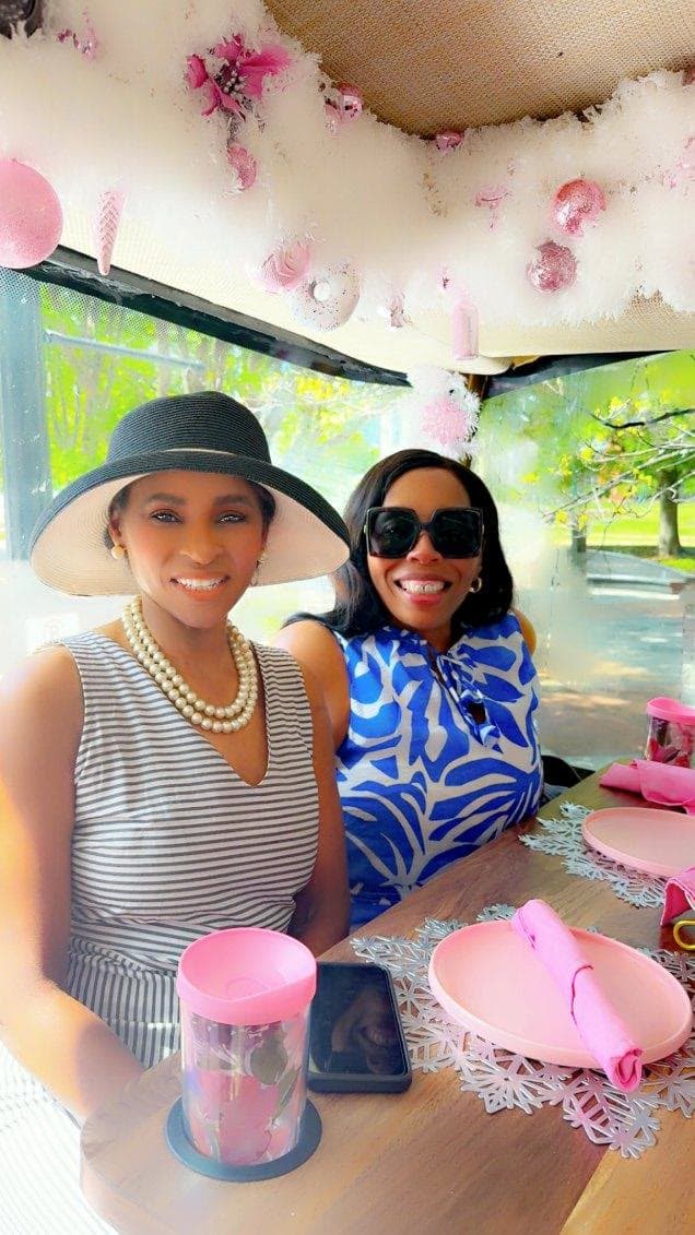 Two LIPSC members in sun hats aboard the tea bus